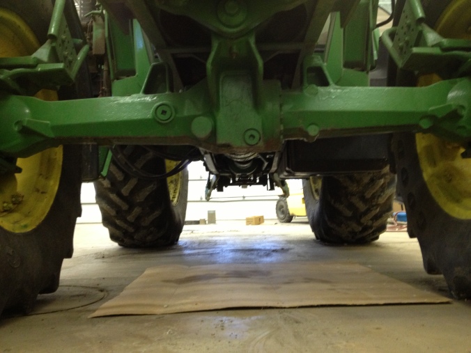 Under our John Deere 6310.  Getting ready to drain the oil into a bucket for it to be recycled.